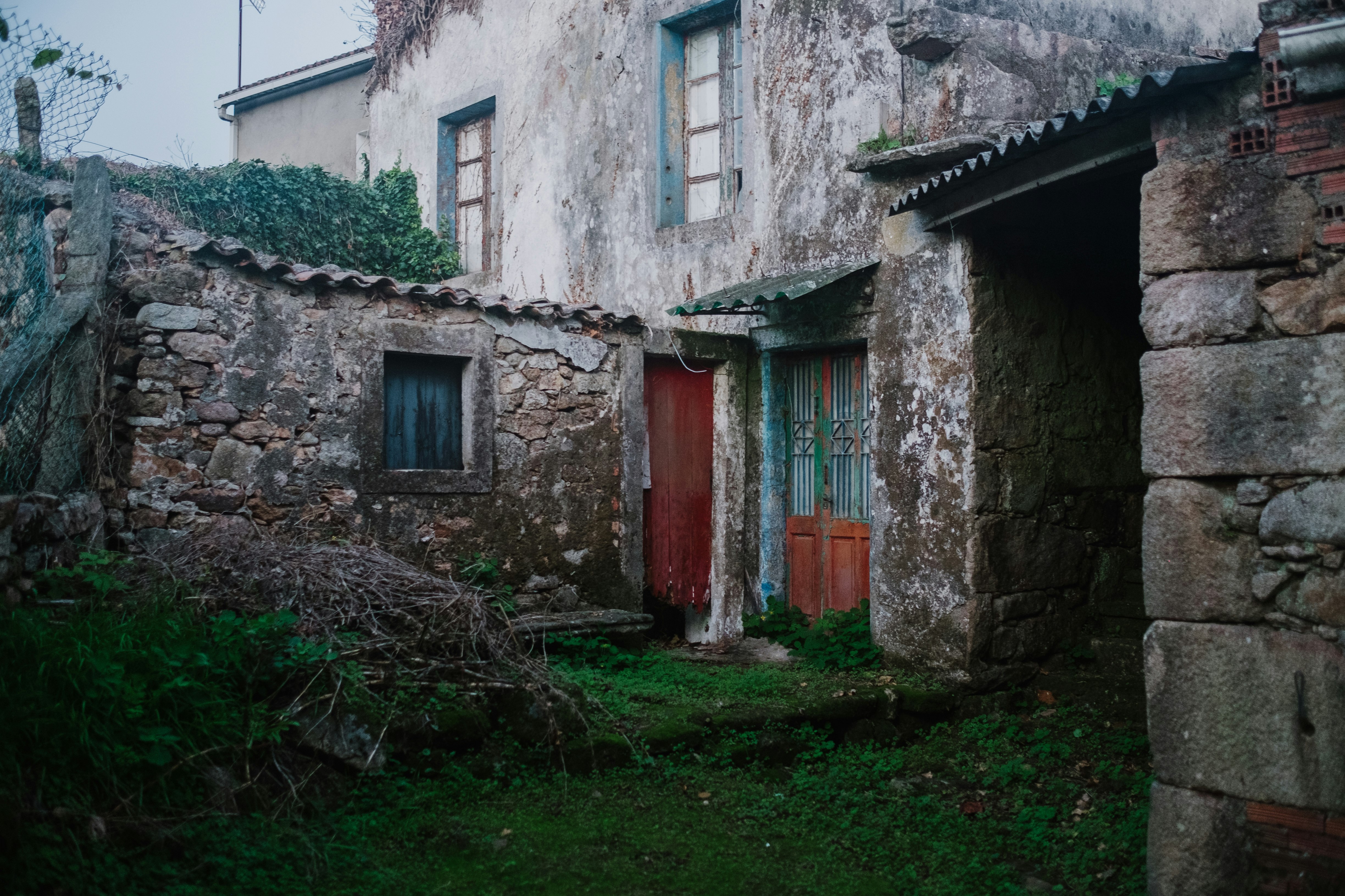 red wooden door on gray concrete building